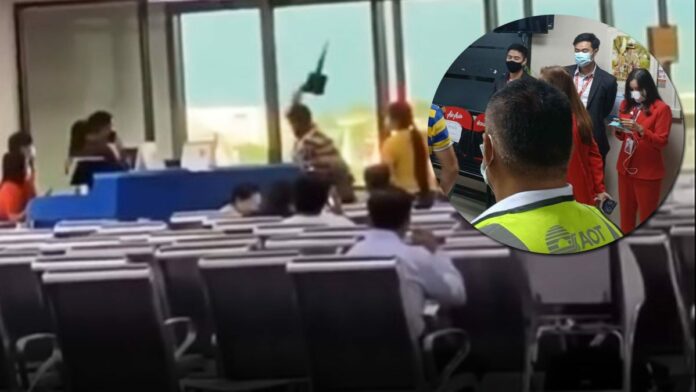 A former policeman smashes a computer at Don Mueang Airport on Aug. 8, 2020 after he was denied boarding for arriving at the gate too late.