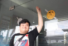 Anti-Gov’t Activists Burn Warrants Before Hearing Protest Charges Activist Parit Chiwarak flashes a three-finger salute after placing “The People’s Party plaque” sticker onto the door of Bang Khen Police Station on Sept. 30, 2020.
