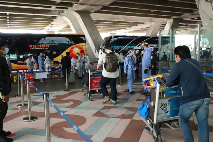 A file photo of people departing to a quarantine facility. A file photo of people departing to a quarantine facility.