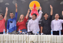 Major Protest to Camp Overnight, March on Government House Parit Chiwarak, Panusaya Sithijirawattanakul, and other activists flash the anti-military “three finger salute” at a news conference at Thammasat University on Sept. 9, 2020.