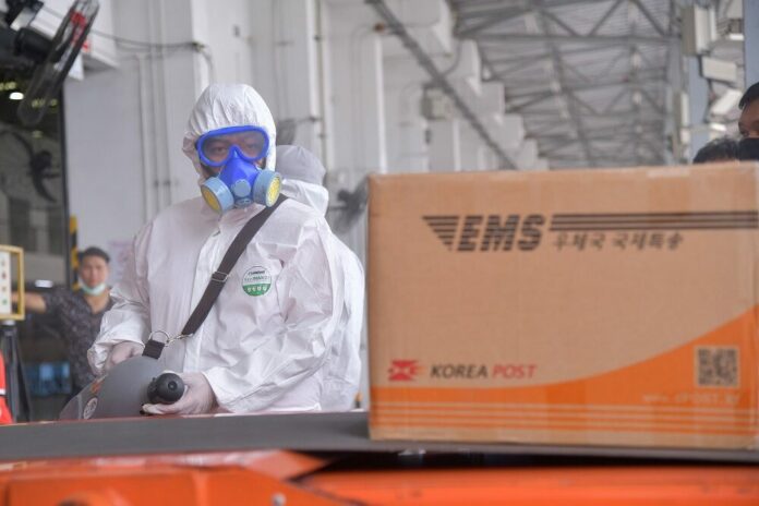 Thailand Post staff disinfect parcels from overseas to prevent coronavirus infection in July 2020.