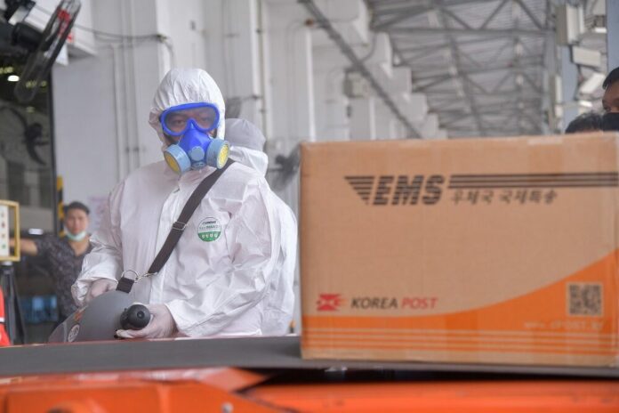 Thailand Post staff disinfect parcels from overseas to prevent coronavirus infection in July 2020. Thailand Post staff disinfect parcels from overseas to prevent coronavirus infection in July 2020.