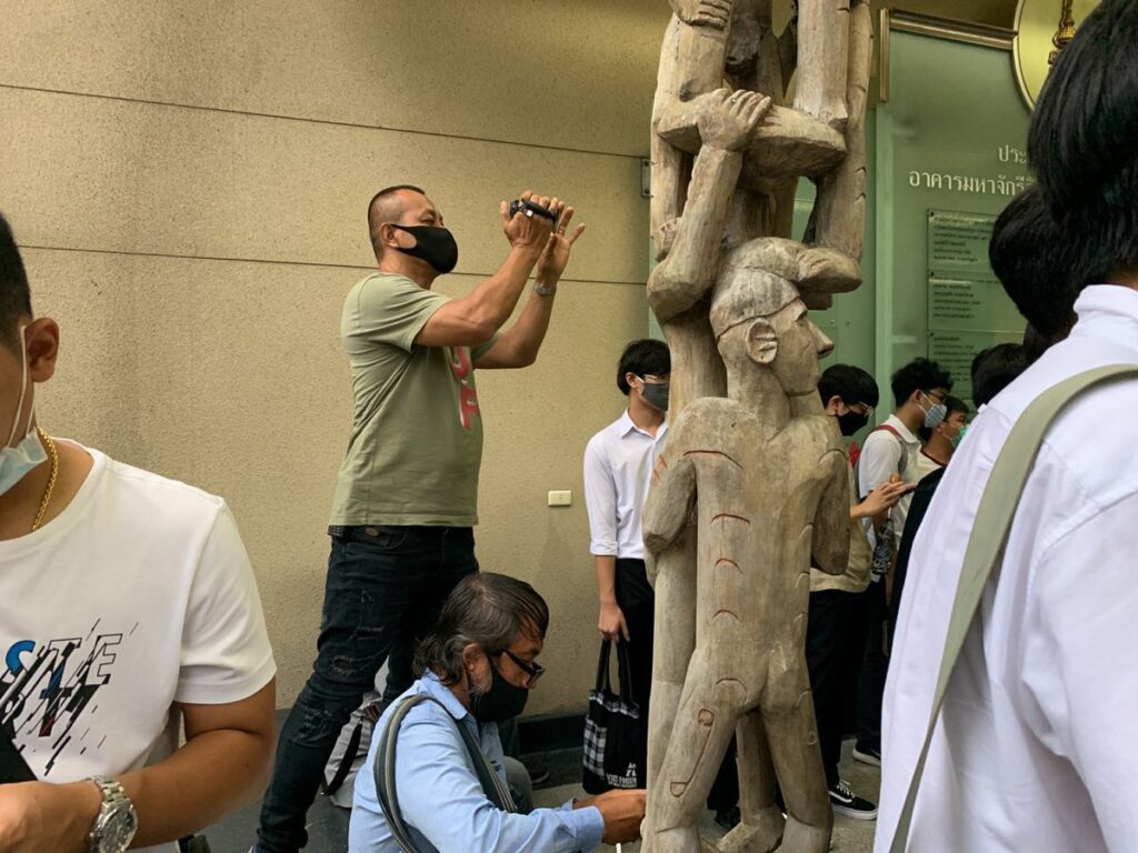 A man believed to be a plain-cloth police officer films an anti-government rally at Chulalongkorn University on Aug. 14, 2020. Photo: iLaw