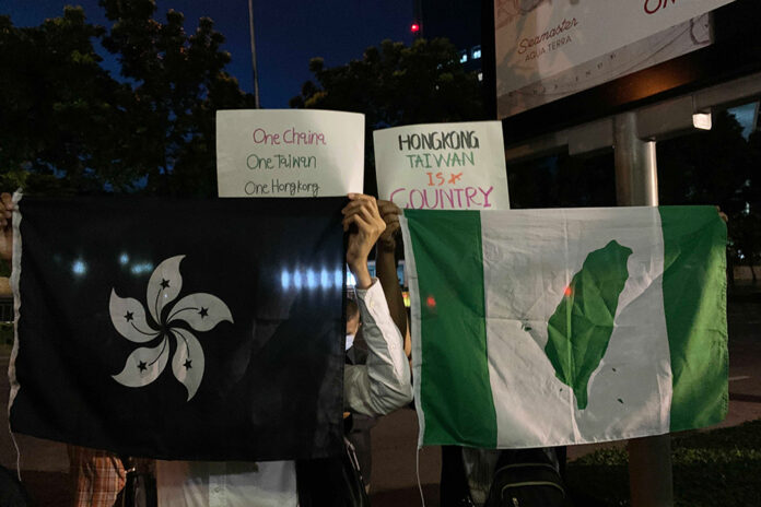Protesters display the flags of the Hong Kong and Taiwan independence movements. Protesters display the flags of the Hong Kong and Taiwan independence movements.