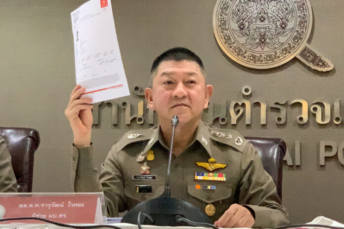 Lt. Gen. Jaruwat Waisaya shows what he said to be a copy of the Interpol Red Notice for Vorayuth “Boss” Yoovidhya during a press conference on Oct. 7, 2020.