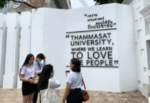 Thammasat Grads to Ditch Commencement Amid Calls of Reforms Students stand by the iconic sign of the university's unofficial motto.