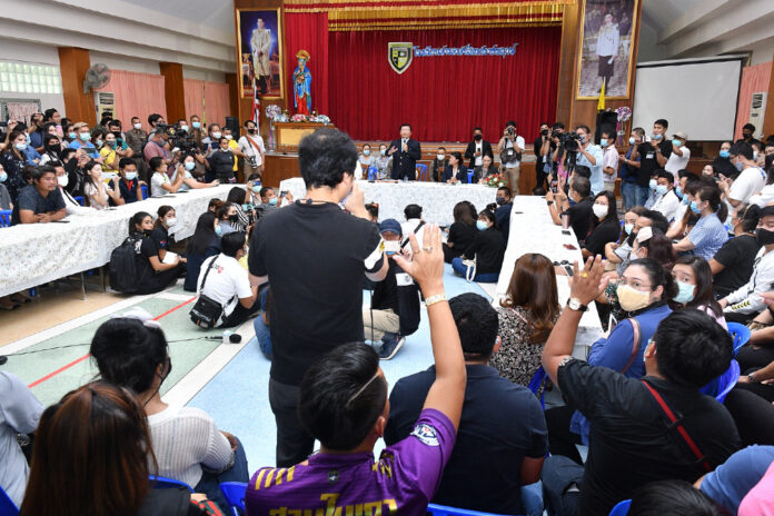 Parents raise their hands to ask questions during a meeting at Sarasas Witaed Ratchaphruek School on Sept. 29, 2020.