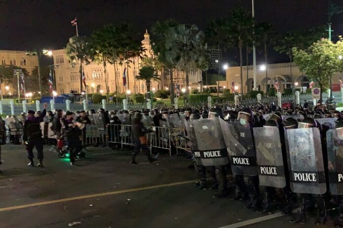Riot police disperse protesters outside Government House on Oct. 15, 2020. Riot police disperse protesters outside Government House on Oct. 15, 2020.