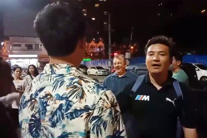 Activist Narathiwat Khamma, in the foreground, argues with Vladislav Timokin during a protest on Nov. 8, 2020.