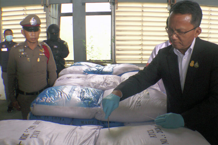 Justice minister Somsak Thepsuthin examines one of the sacks believed to be containing ketamine during the raid of a warehouse in Chachoengsao province on Nov. 12, 2020. Justice minister Somsak Thepsuthin examines one of the sacks believed to be containing ketamine during the raid of a warehouse in Chachoengsao province on Nov. 12, 2020.