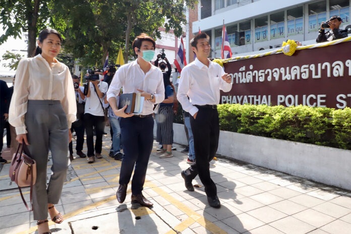 Former leaders of the now-disbanded Future Forward Party Pannika Wanich, Piyabutr Saengkanokkul, and Thanathorn Juangroongruangkit at Phayathai Police Station on Nov. 5, 2020.