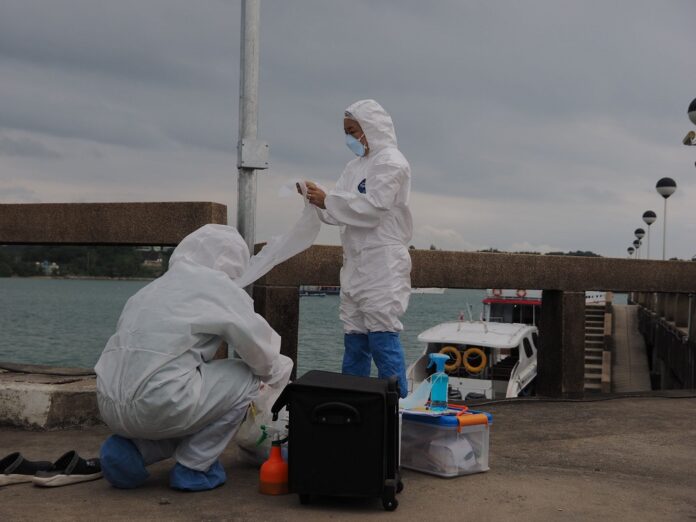 Health workers in protective suits prepare to test yachters from Australia and Malaysia for coronavirus in Phuket province on Nov. 27, 2020.