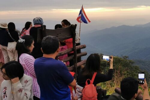 Visitors take photos of the sunrise in Suphanburi province on Dec. 12, 2020.