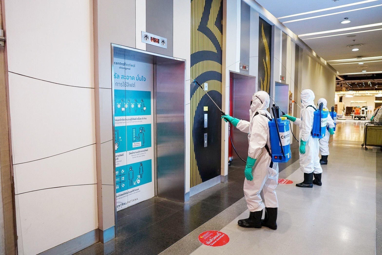 Workers spray disinfectants at a shopping mall in Chiang Mai province.