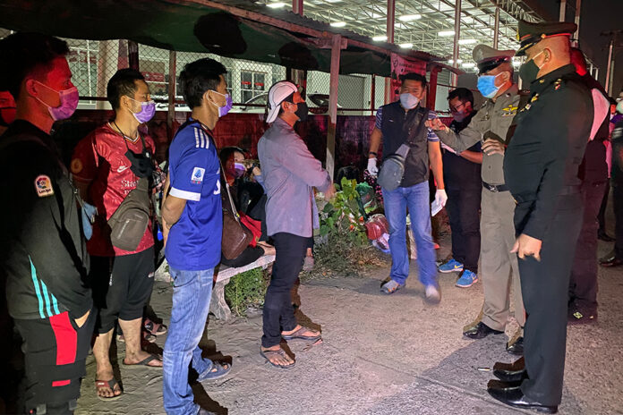 Security officials question a group of migrant workers left abandoned in front of a factory in Samut Prakan province on Dec. 22, 2020. Security officials question a group of migrant workers left abandoned in front of a factory in Samut Prakan province on Dec. 22, 2020.