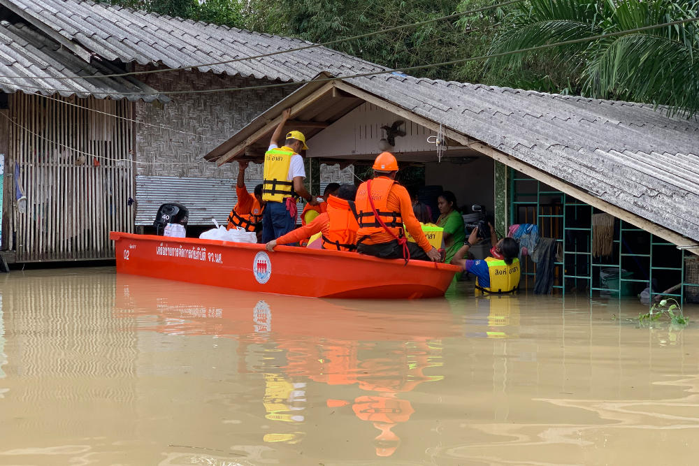 Rescue workers deliver supplies to residents affected by flooding in Nakhon Si Thammarat province on Dec. 4, 2020.