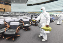 Reports: Infected Gambler Was at Parliament To Testify About Gambling A worker disinfects the parliament's main chamber on Feb. 28, 2020.