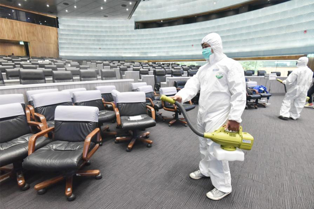 A worker disinfects the parliament's main chamber on Feb. 28, 2020.