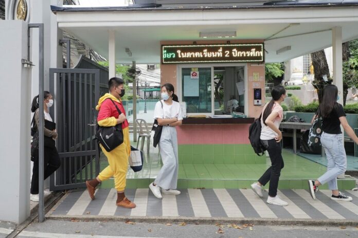 Students, some wearing casual outfits, arrive at Samsen Witthayalai School in Bangkok on Dec. 1, 2020.