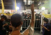 Protest Guards Charged for Clearing Razor Wires Left By Cops A protester outside Phayathai Police Station on Dec. 7, 2020.