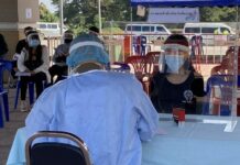 38 People Infected So Far In Connection With Myanmar Returnees A woman receives a coronavirus test in Chiang Rai province on Dec. 7, 2020.