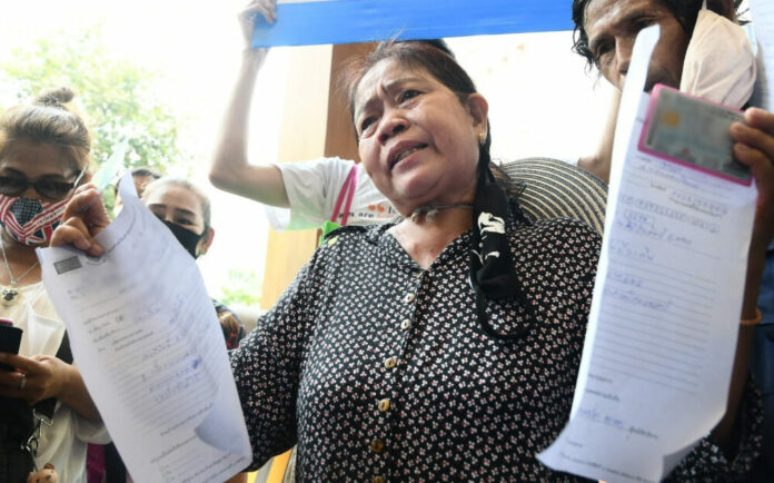 A woman files complaints to the finance ministry on May 5, 2020, for payment delays in the