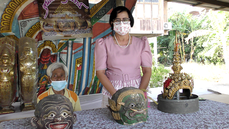 Vanida, standing, with her family’s collection of theater masks.