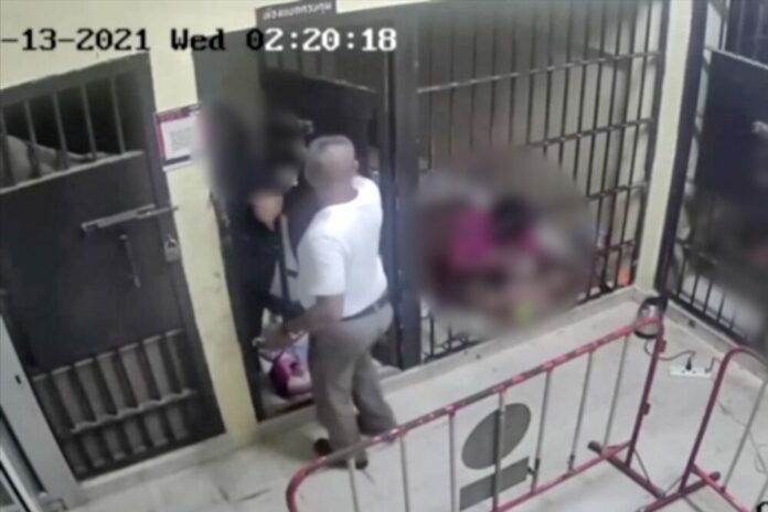 A screenshot of a CCTV footage at Bo Phut Police Station released by investigators shows the moment Sergeant Major Watcharin Silpsamosorn took out the victim from her cellroom on Jan. 13, 2021. A screenshot of a CCTV footage at Bo Phut Police Station released by investigators shows the moment Sergeant Major Watcharin Silpsamosorn took out the victim from her cellroom on Jan. 13, 2021.