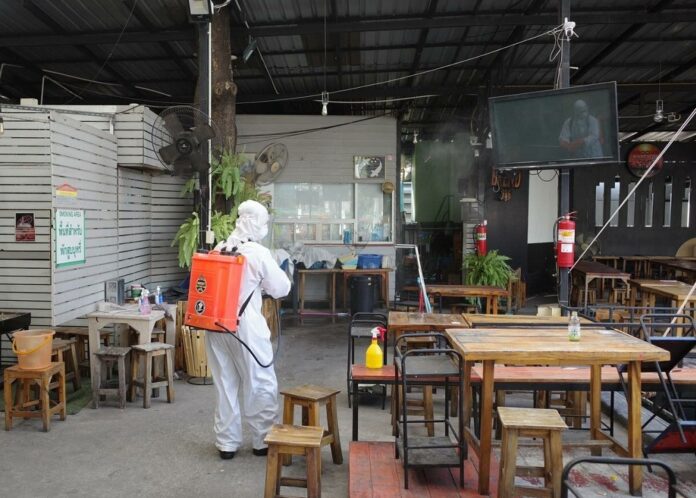 Workers disinfect a restaurant in Bangkok on Jan. 5, 2021.