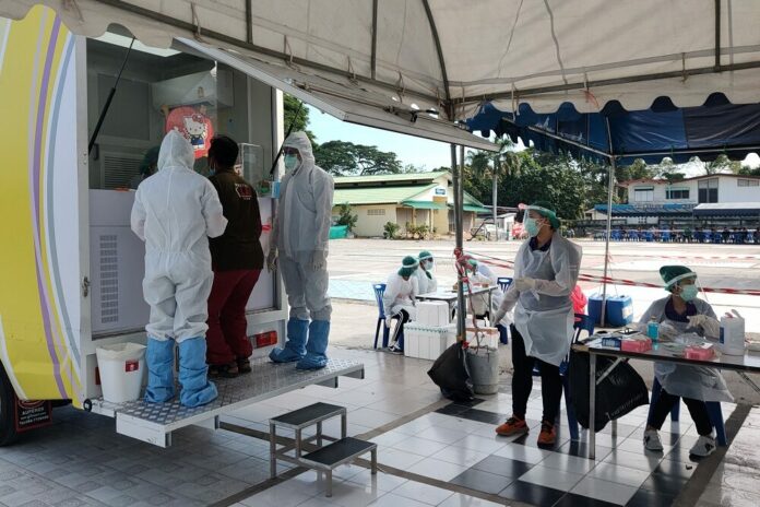 A man receives a coronavirus test on Jan. 3, 2021, at a mobiling testing unit in Rayong province. A man receives a coronavirus test on Jan. 3, 2021, at a mobiling testing unit in Rayong province.