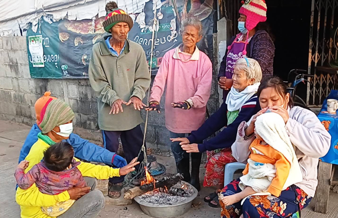 People in Korat city gather around a fire on Jan. 13, 2021 during a nationwide cold spell.