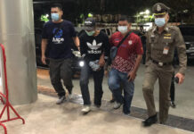 Protest Guards Arrested for Bomb Attack Wounding 5 Police escort one of the suspects to Pathum Wan Police Station on Jan. 28, 2021.
