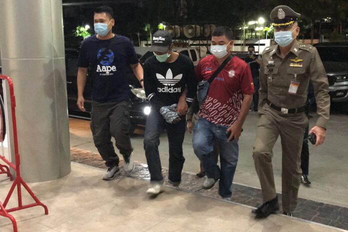 Police escort one of the suspects to Pathum Wan Police Station on Jan. 28, 2021. Police escort one of the suspects to Pathum Wan Police Station on Jan. 28, 2021.