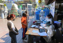 Chiang Mai Walks Back Promise to Pay Infected Tourists 100,000 Baht People line up for coronavirus tests at a screening station in front of Warm Up Cafe in Chiang Mai City on Jan. 5, 2021. Photo: Warm Up Cafe / Facebook