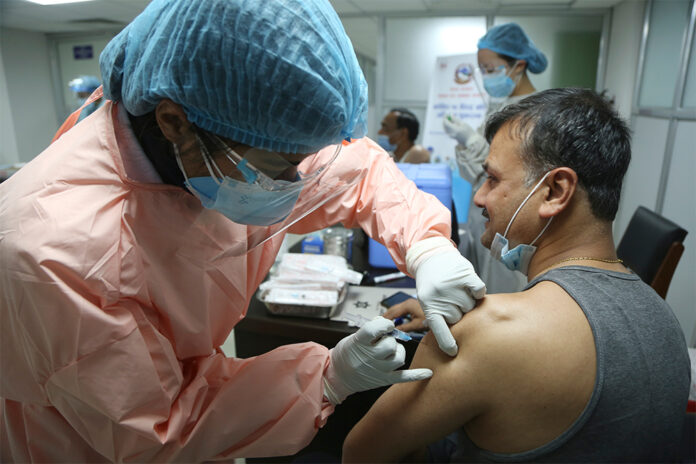 A Nepalese doctor receives AstraZeneca/Oxford University vaccines, manufactured under license by Serum Institute of India at Teaching Hospital in Kathmandu, Nepal on Jan. 27, 2021. Photo: Niranjan Shrestha / AP A Nepalese doctor receives AstraZeneca/Oxford University vaccines, manufactured under license by Serum Institute of India at Teaching Hospital in Kathmandu, Nepal on Jan. 27, 2021. Photo: Niranjan Shrestha / AP