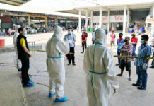 2 Mil. Doses of Chinese Vaccine Will Go to Frontline Health Workers Health workers talk to migrant workers who are being quarantined at the field hospital inside the shrimp market in Samut Sakhon province on Dec. 25, 2020.