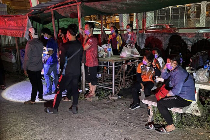 A group of migrant workers left abandoned in front of a factory in Samut Prakan province on Dec. 22, 2020.