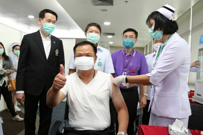 In this May 8, 2020, file photo, health minister Anutin Charnvirakul receives a flu vaccine at the Ministry of Public Health in Bangkok.