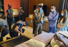 Cops Say Owner of Casino in Virus Outbreak Arrested, 2 Months Later Somchai Jutikitdet, right, in blue shirt, during the police raid of his home in Rayong City on Feb. 11, 2021.