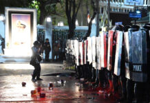 Reporters Say Cops Blocked Them from Covering the Grand Palace Crackdown A photographer takes a photo during the clashes between anti-government protesters and police near the Grand Palace on Feb. 13, 2021.