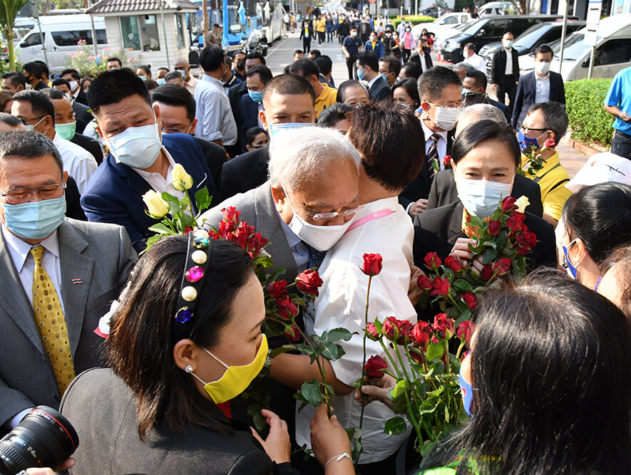 Suthep Thaugsuban, center, receives a hug from his supporter before entering the Criminal Court to hear his verdict on Feb. 24, 2021.