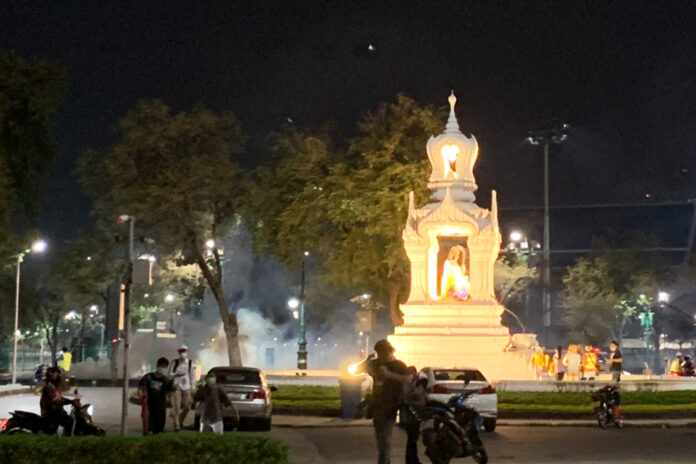 A cloud of smoke emerges near the Phra Mae Thorani Shrine during the police crackdown on demonstrators on Feb. 13, 2021.