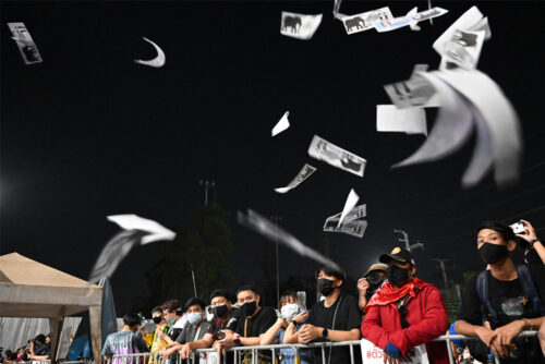 Demonstrators toss mock “Elephant Tickets” during an anti-government rally in front of the parliament on Feb. 20, 2021.