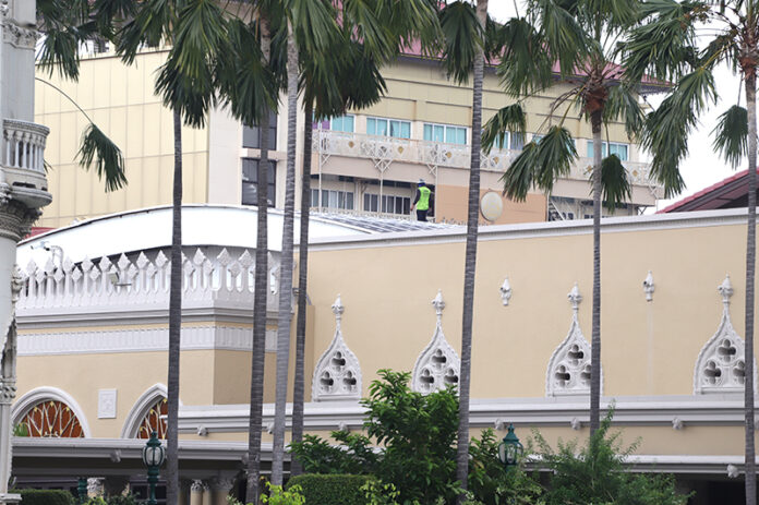 A repairman on the roof of Government House for repairs on March 11, 2021.