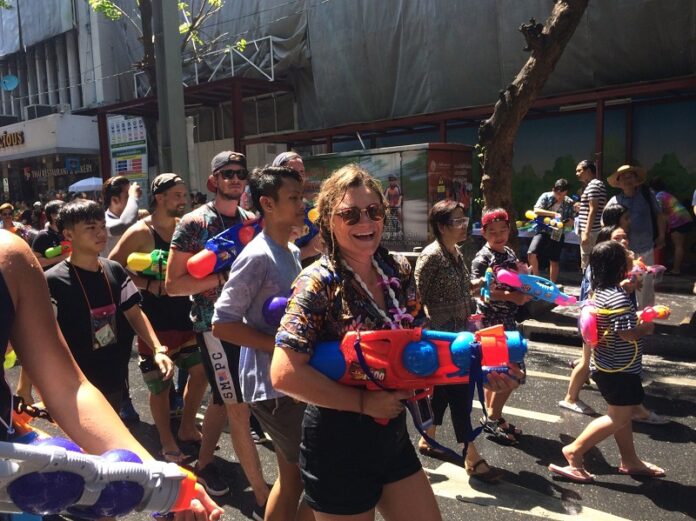 People with water guns on Silom Road during Songkran 2017.