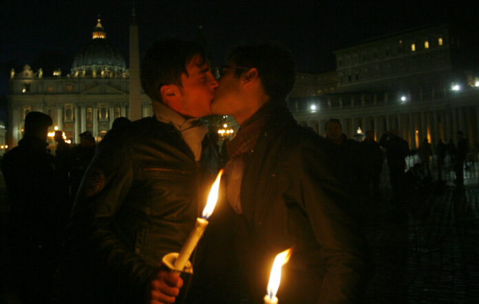 FILE - In this Saturday Dec. 6, 2008 file photo two men kiss each other outside St. Peter's Square at the Vatican during a candle-lit demonstration for gay rights. Photo: Alessandra Tarantino / AP File