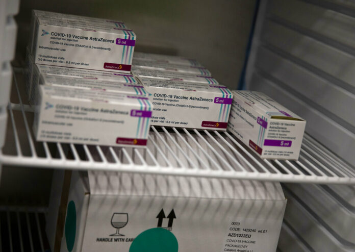 Boxes of the AstraZeneca COVID-19 vaccine are stored in a refrigerator at the Vaccine Village in Antwerp, Belgium on Tuesday, March 16, 2021. Photo: Virginia Mayo / AP