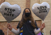Asian Americans Grieve, Organize in Wake of Atlanta Attacks FILE - In this March 13, 2021, file photo, Chinese-Japanese American student Kara Chu, 18, holds a pair of heart balloons decorated by herself for the rally "Love Our Communities: Build Collective Power" to raise awareness of anti-Asian violence outside the Japanese American National Museum in Little Tokyo in Los Angeles. Photo: Damian Dovarganes / AP File