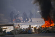 Myanmar Forces Kill Scores in Deadliest Day Since Coup Protesters gather tires to add to the fires set during a rally against the military coup Saturday, March 27, 2021, in Tarmwe township in Yangon, Myanmar. Photo: AP