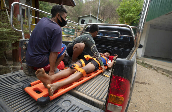 An injured Karen villager from Myanmar is transported at Ban Mae Sam Laep Health Center, Mae Hong Son province, northern Thailand, after crossing Salawin river on a boat, on Tuesday March 30, 2021. Photo: Sakchai Lalit / AP
